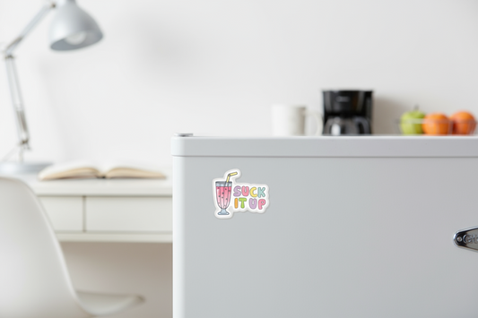 Fridge with a colorful sticker on a kitchen counter